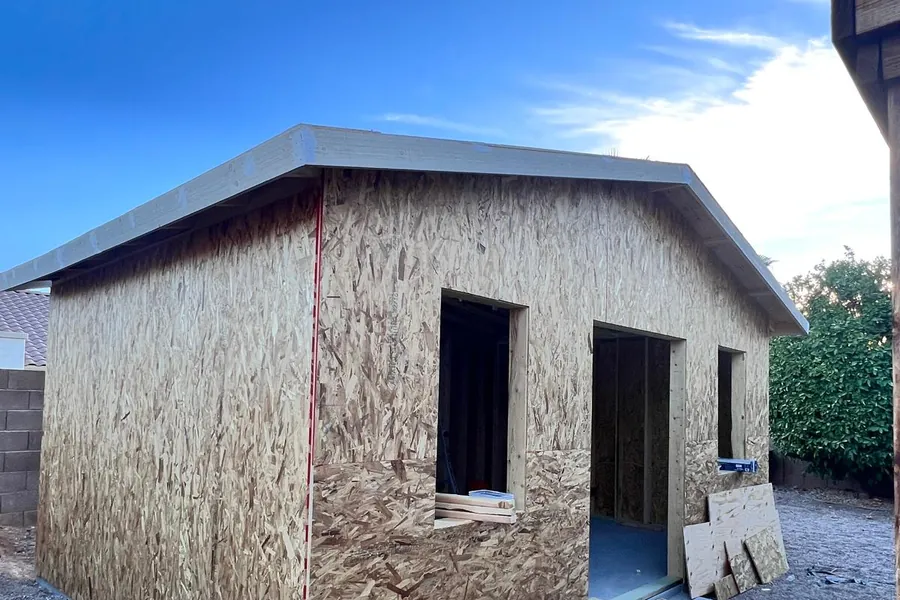 The sheathed shell of a casita with its roof on and openings cut