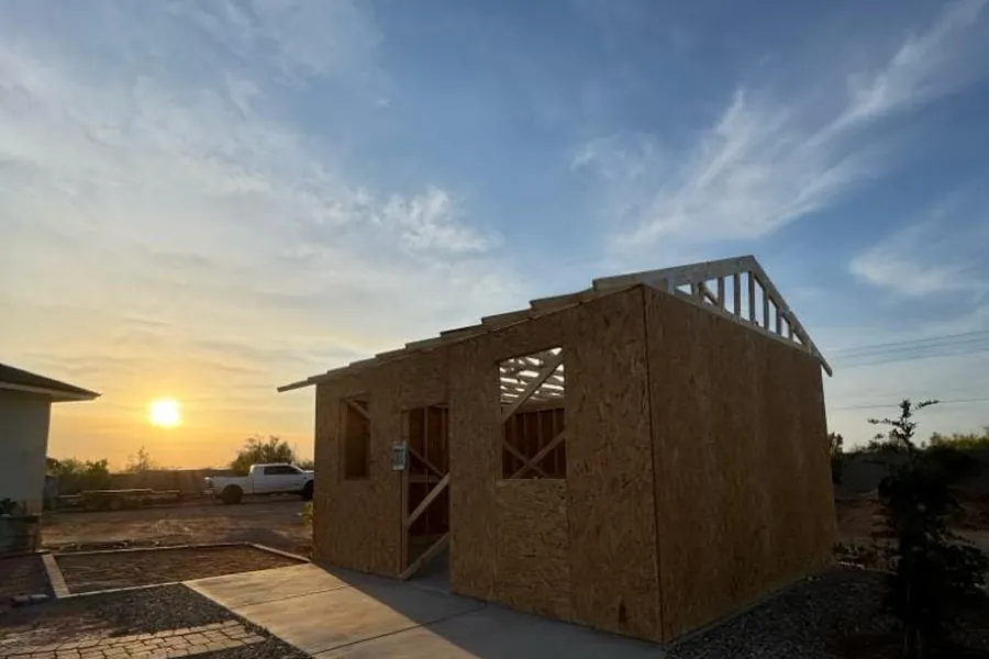 A sheathed casita on its slab at sunset
