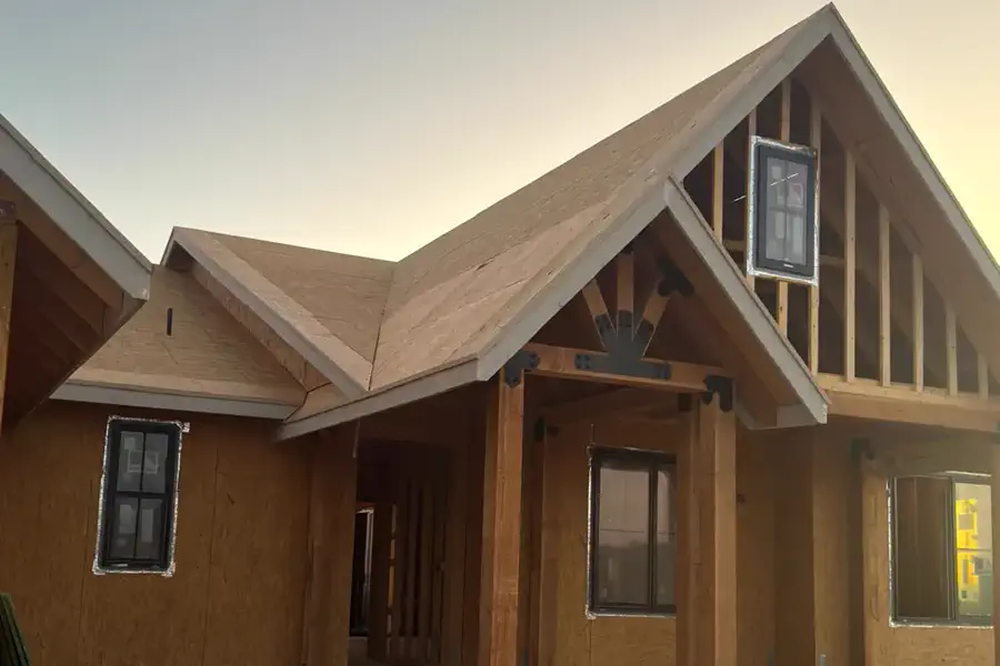The front porch and timber posts of a custom home at dusk