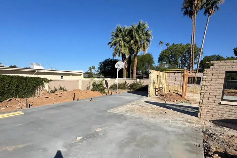 A freshly poured and floated concrete slab on a Quest Construction build