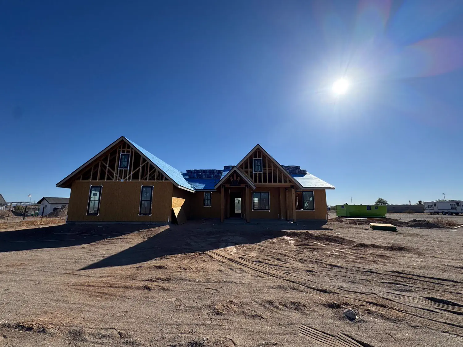 A Quest Construction custom home under construction on an open Arizona lot
