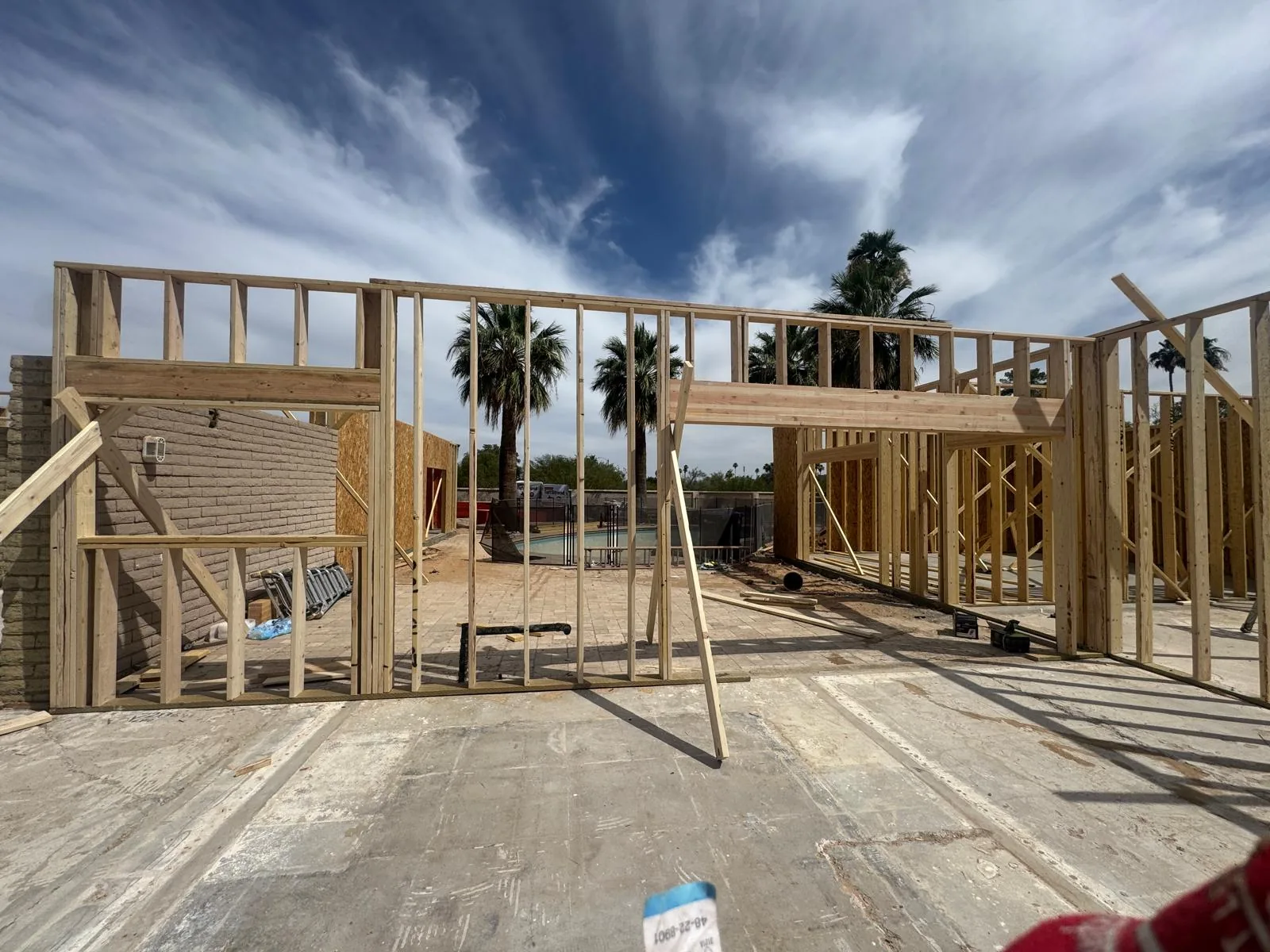Framed walls and a header under an Arizona sky