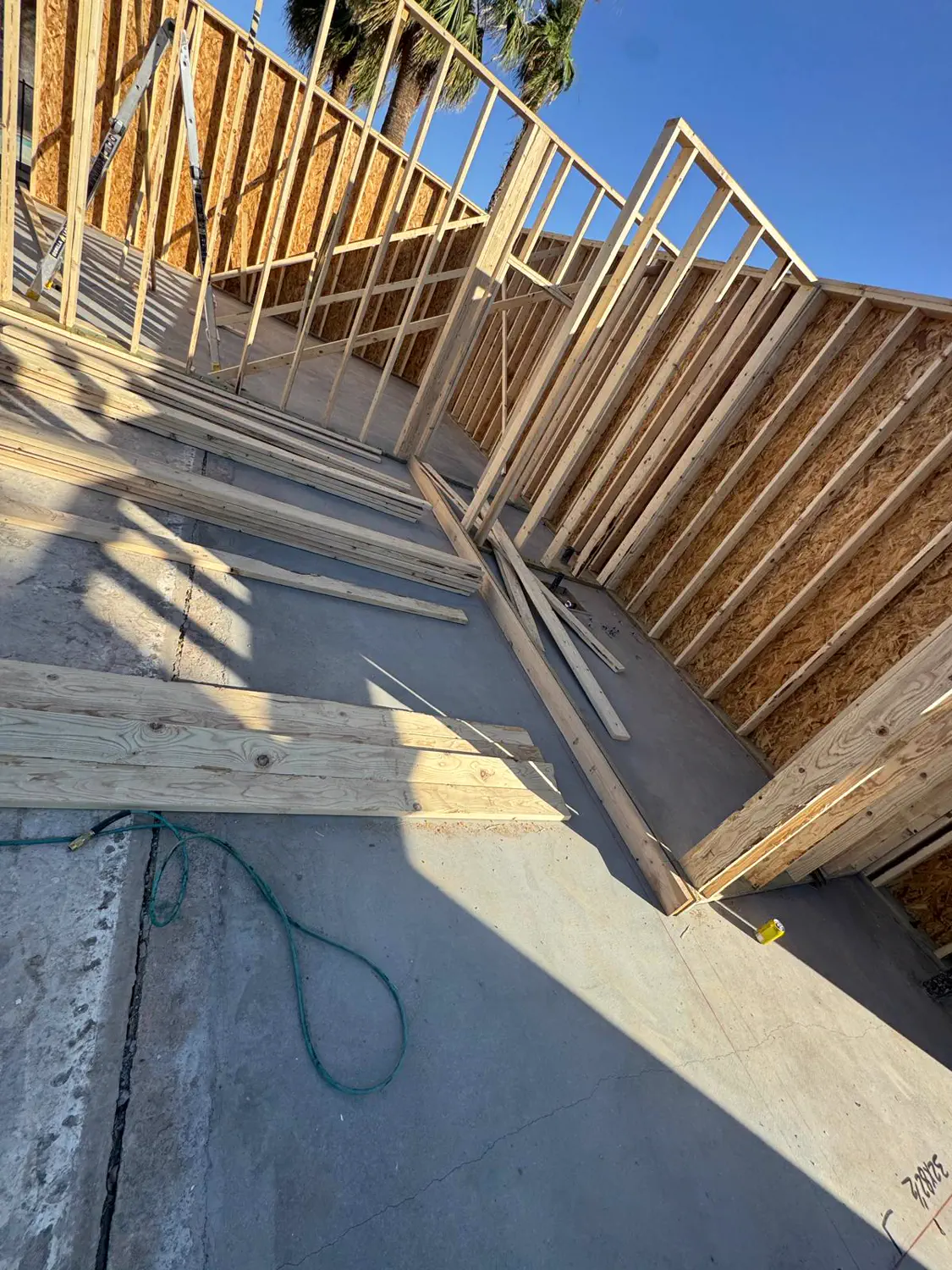 An air hose run through the framed walls of a Quest Construction build