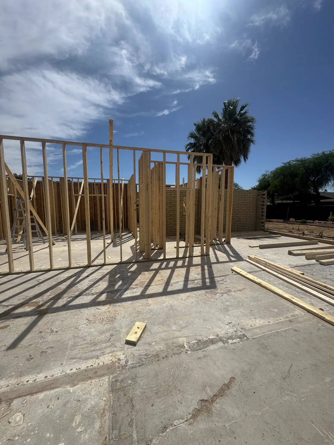 Framed walls against a clear Arizona sky