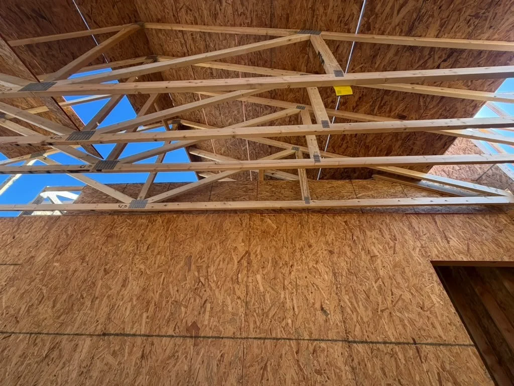 Roof trusses framed above the interior of a home
