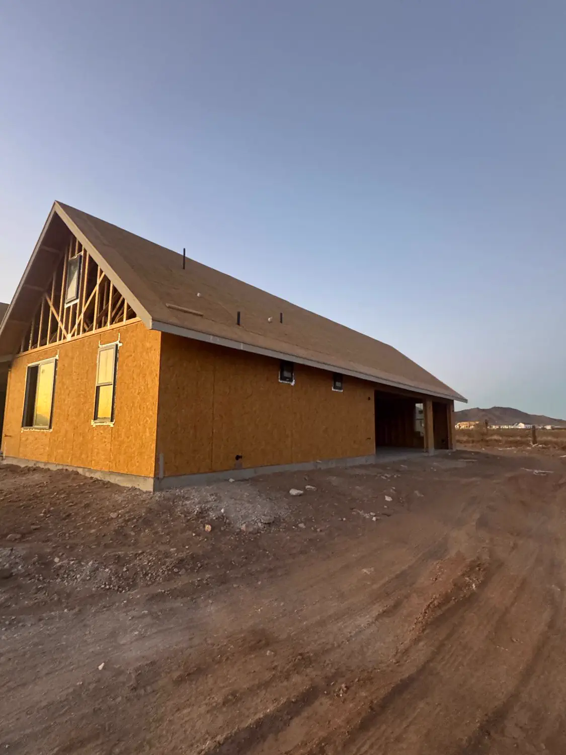 A custom home shell from the side at the end of the day
