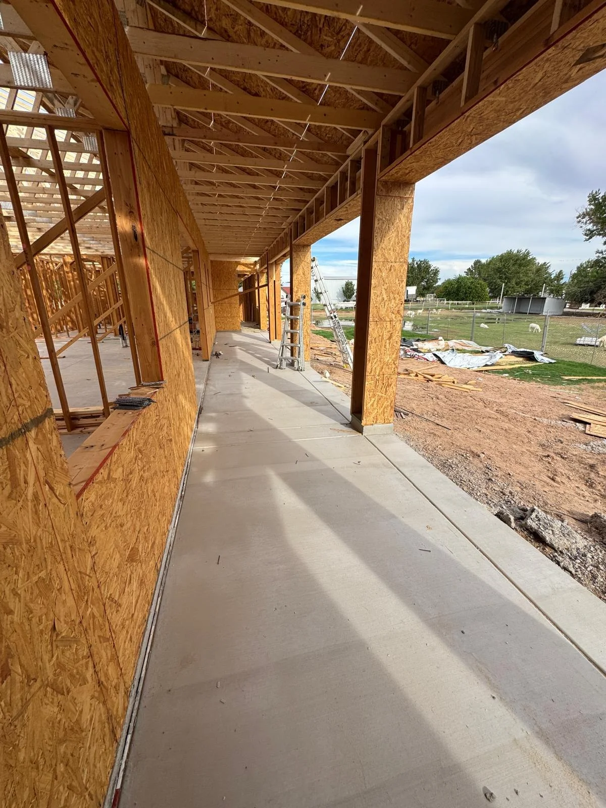 Concrete walkway beside the home construction