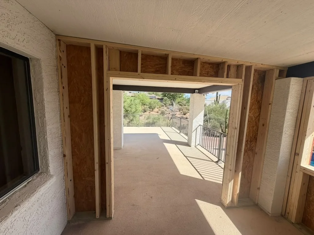 A new header above a wide opening at a covered patio