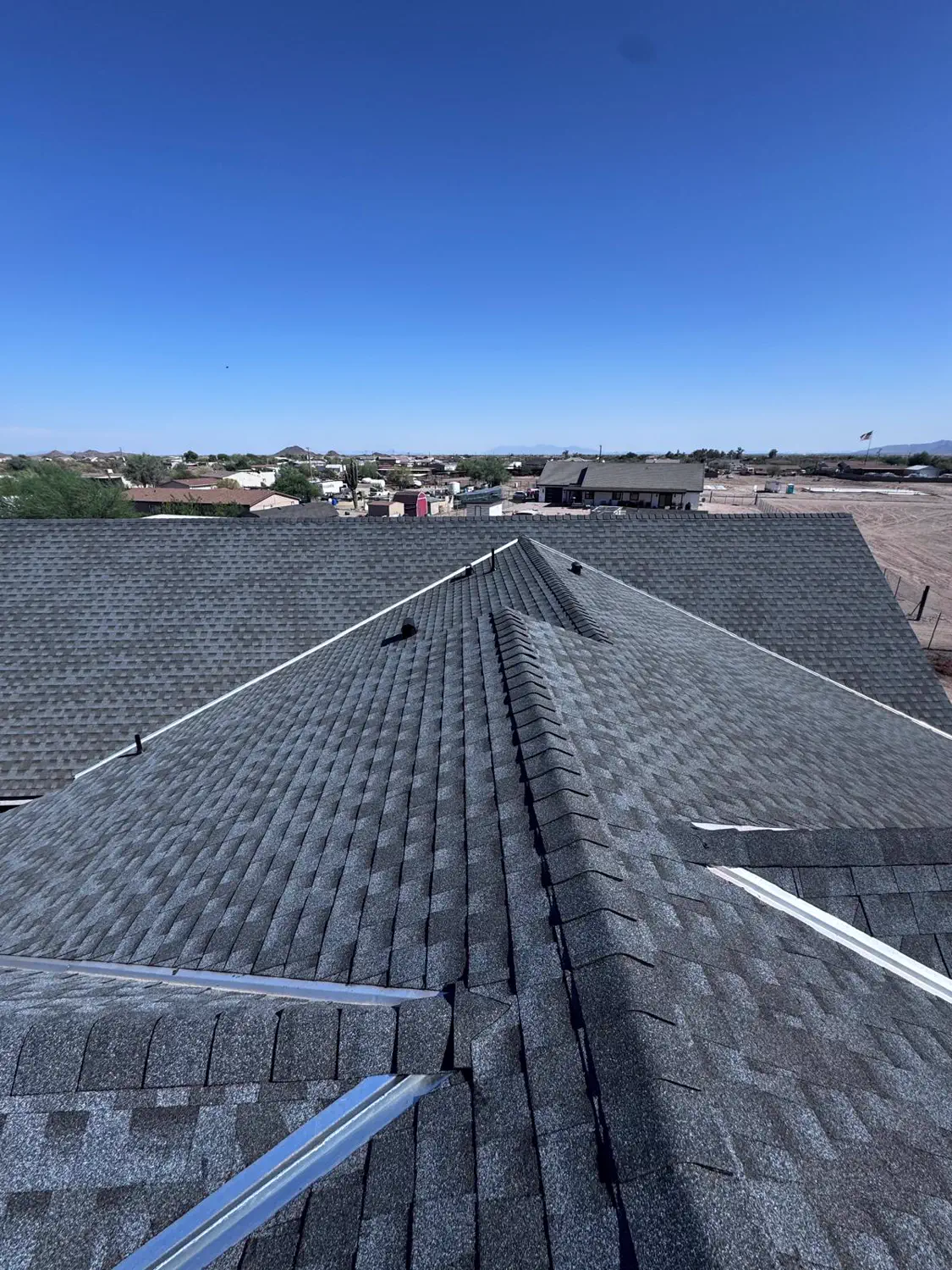 The ridge line of a newly shingled roof