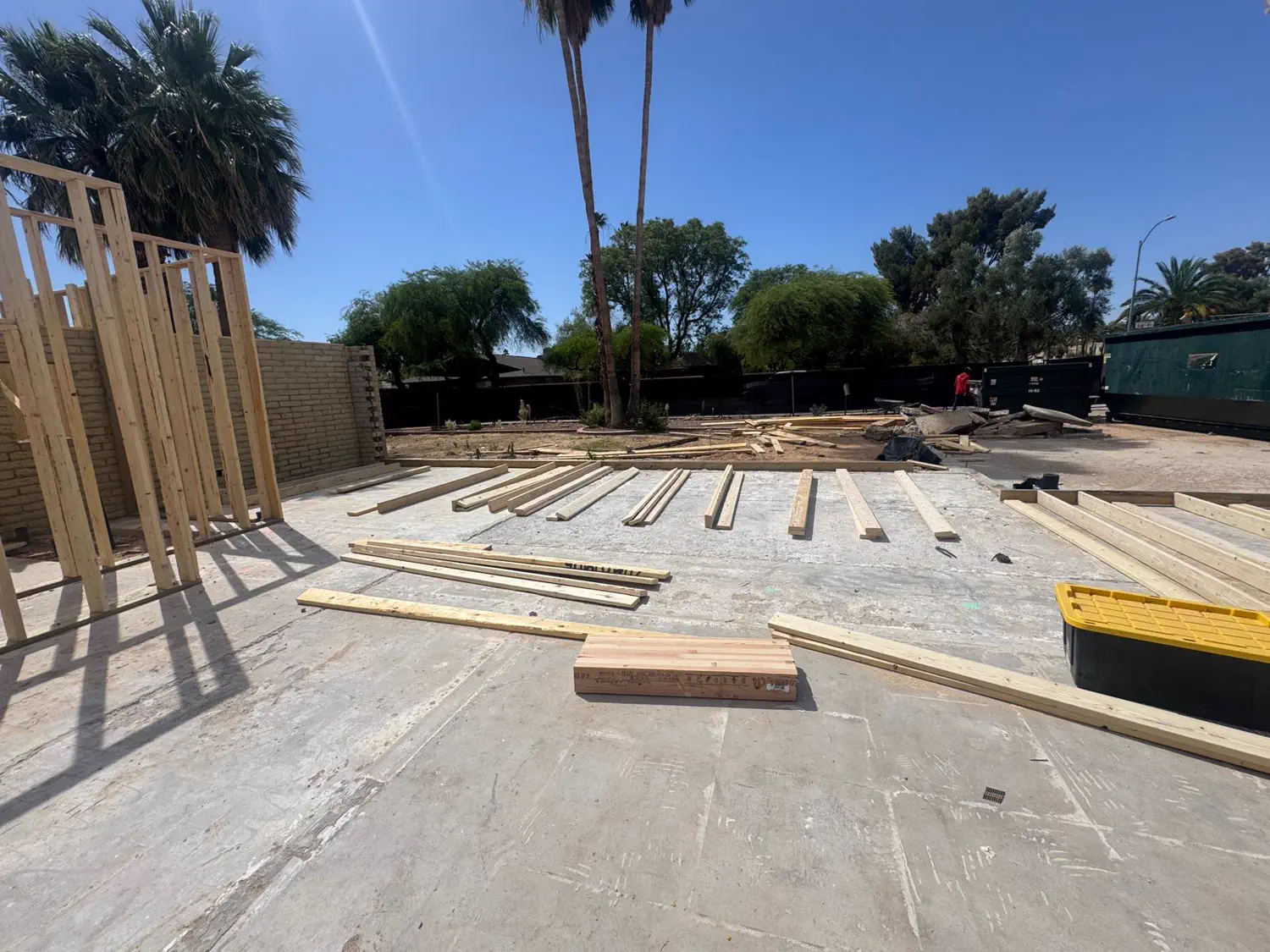 Framing lumber laid out across a finished slab