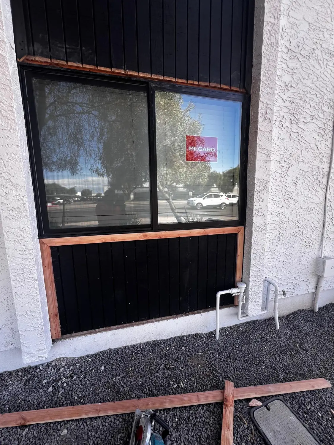 A new window fitted into a widened opening with fresh siding below it