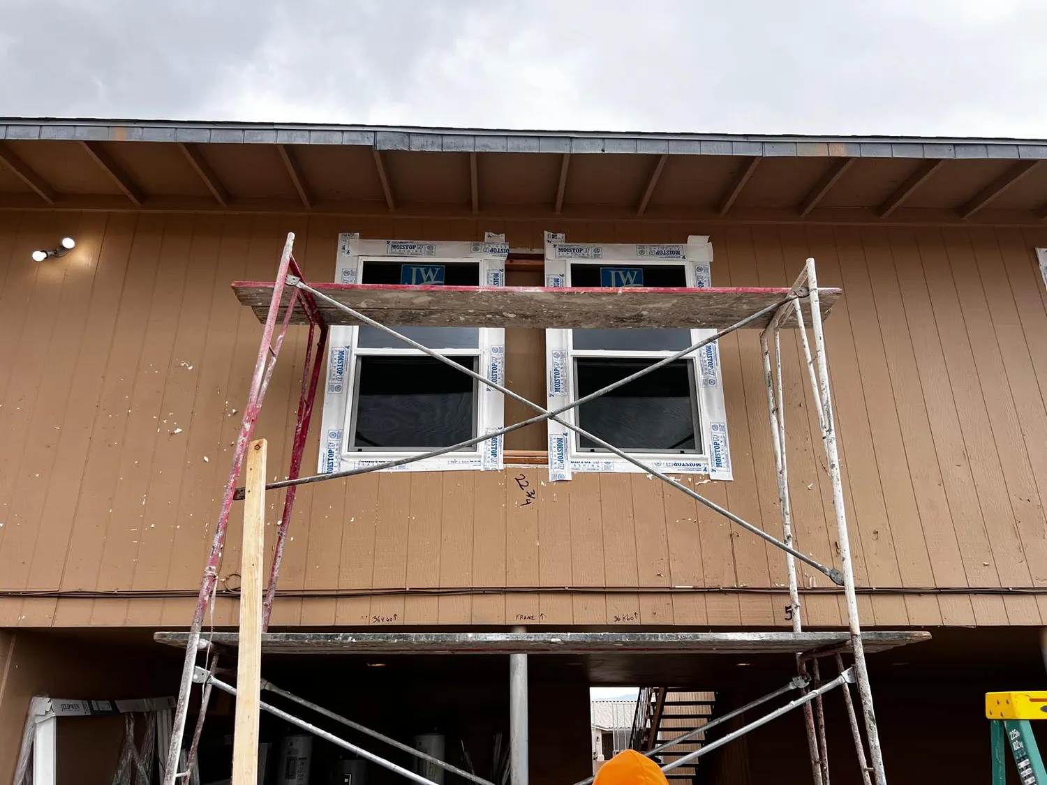 Two new windows going into an upper storey from a scaffold