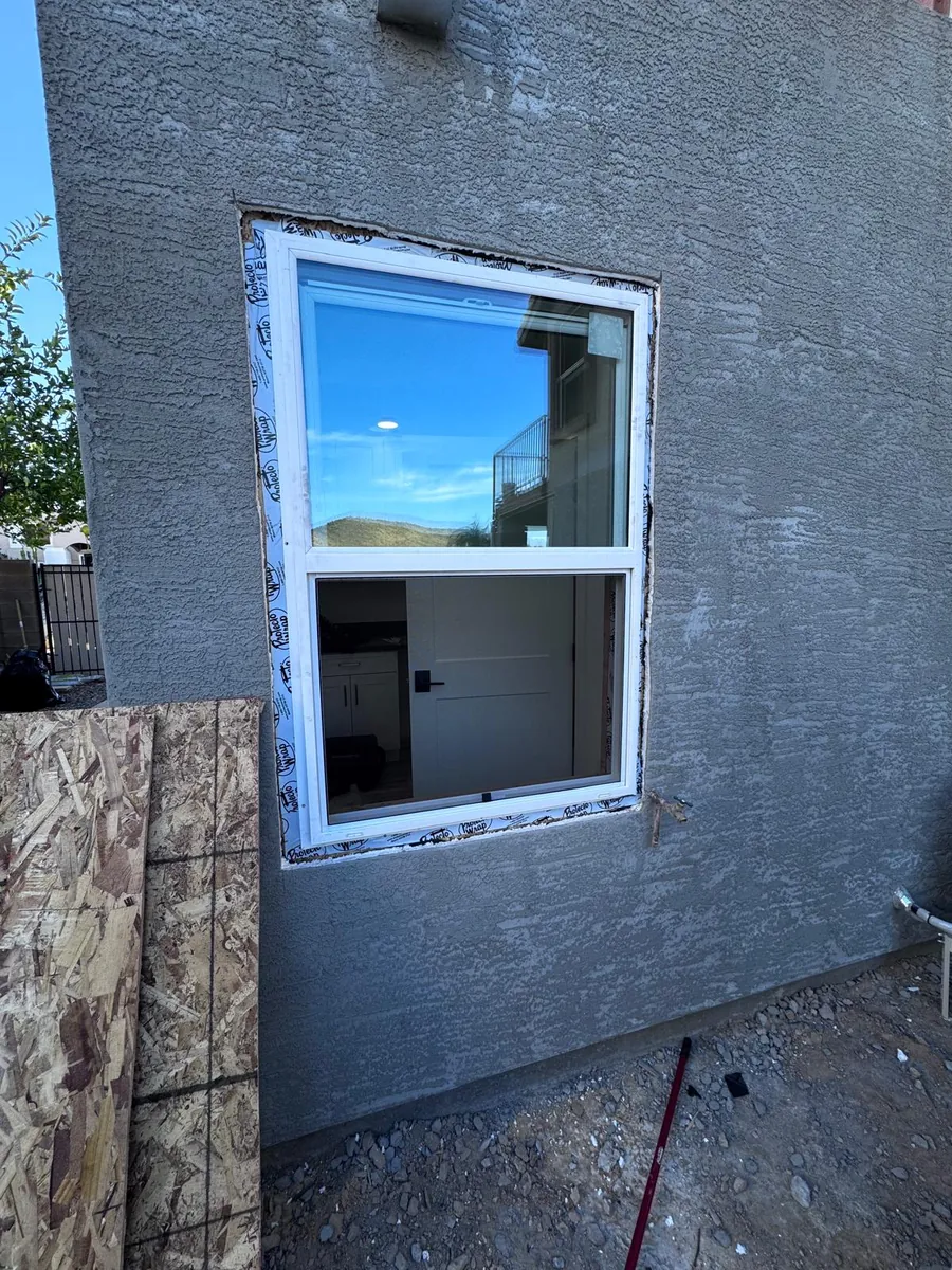 A new window set and flashed into a stucco wall
